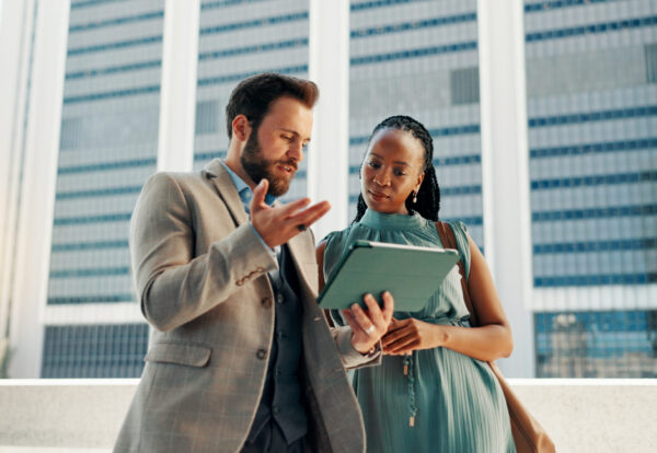 Tablet, rooftop and business people in discussion in city for planning company investment with stocks. Digital technology, strategy and manager with financial advisor for online with risk management